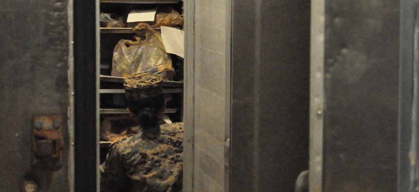 A Marine searches for frozen Commissary items in a CATC Camp Fuji mess hall freezer in March 2023.
