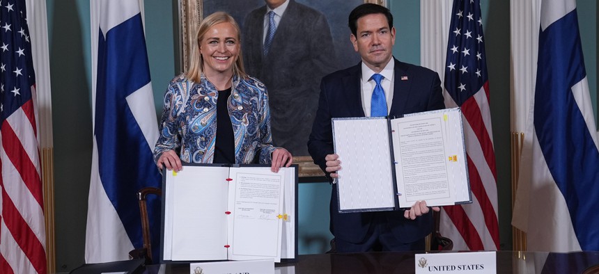 U.S. Secretary of State Marco Rubio (R) and Finnish Foreign Minister Elina Valtonen (L) sign a memorandum of understanding during a signing ceremony in the Treaty Room at the U.S. Department of State in Washington, D.C., on October 29, 2026.