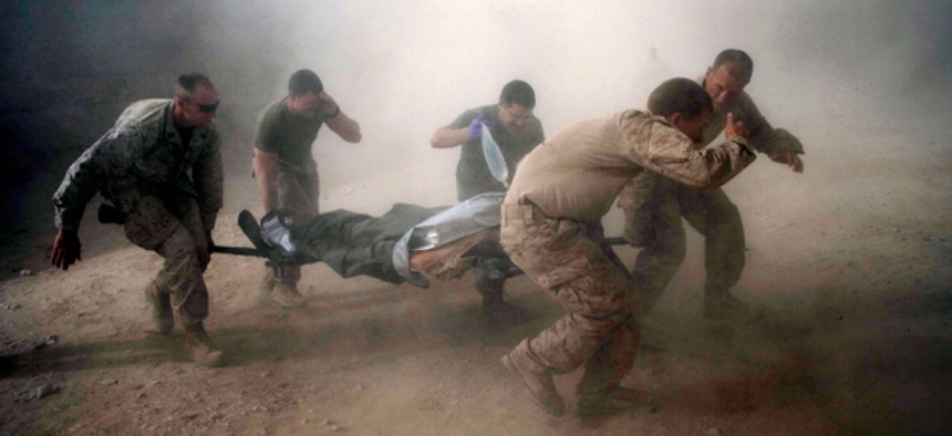 U.S. Marines rush a colleague wounded in an IED strike to a helicopter for evacuation.