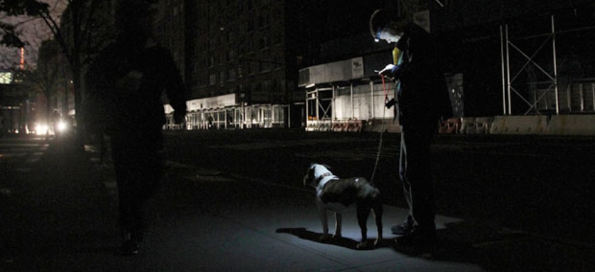 A New York woman checks her voicemail the night after the storm on her phone.