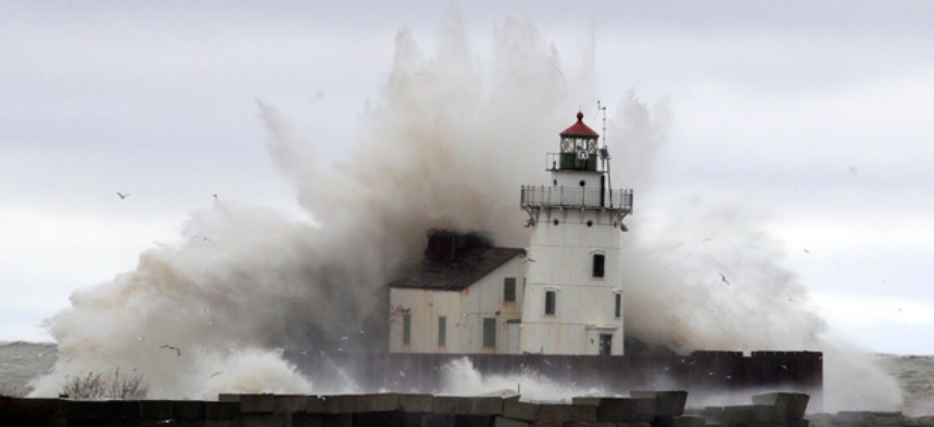 Waves pound a lighthouse as Hurricane Sandy hits the shores of Lake Erie, Tuesday.