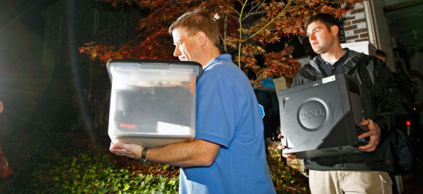 FBI agents carry computers and boxes of printed documents from Paula Broadwell's home Tuesday.