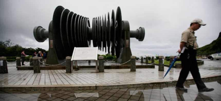 A security officer in 2011 walks past a low-pressure turbine rotor at an atomic energy site in Taiwan's Wanli district.