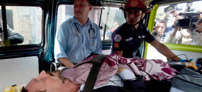 Software company founder John McAfee lies inside an ambulance, to be transferred from an immigration detention center to a hospital, in Guatemala City.