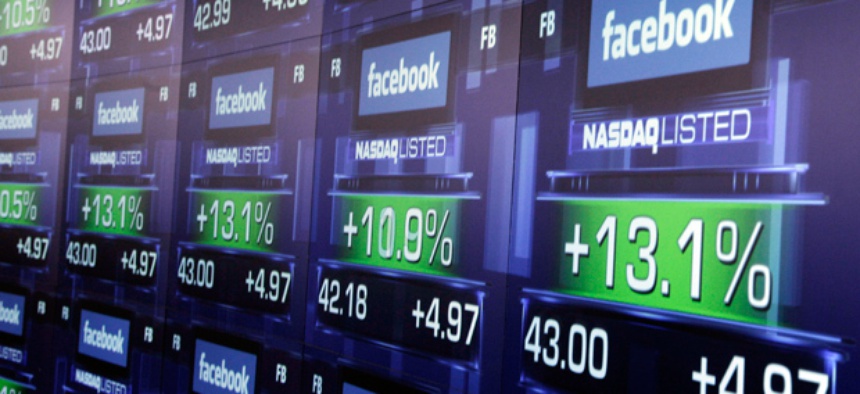 Electronic screens show the price of Facebook shares after they began trading Friday, May 18, 2012 in New York.
