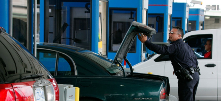 U.S. Customs and Border Patrol officer Jefferey Hill checks the trunk of a motorist's vehicle entering the United States at the border crossing in Buffalo, N.Y.