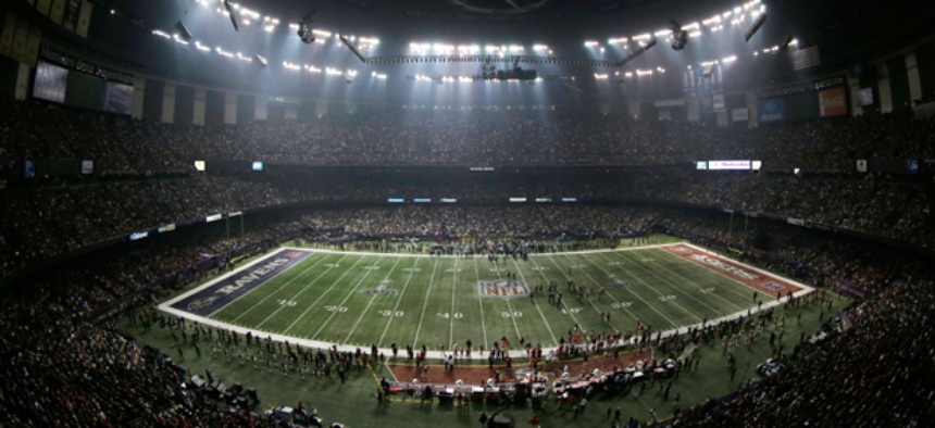 Fans and members of the Baltimore Ravens and San Francisco 49ers wait for power to return in the Superdome.