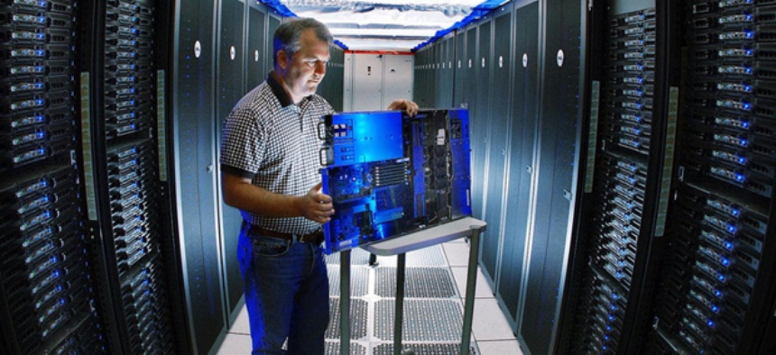 A Sandia reseracher inspects a Thunderbird supercomputer component.