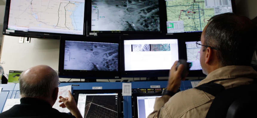 Activities of a Predator B unmanned aircraft are monitored at the Naval Air Station.