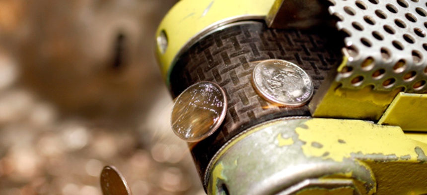 Coins from the initial strike of Arizona quarters tumble out of the press and into a collection bin during a ceremony at the U.S. Mint in Denver.