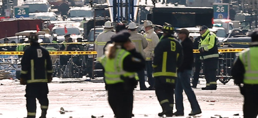 Emergency responders walked toward the finish line Monday.