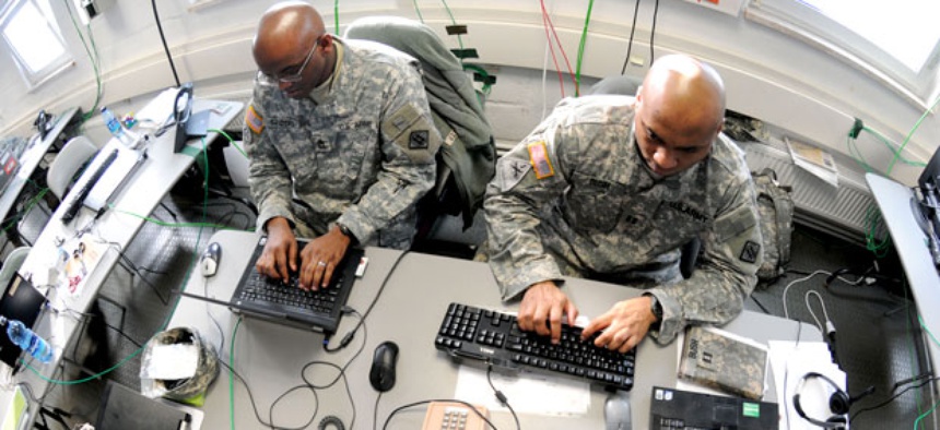 aster Sgt. Charlie Sanders (left) and Capt. Lashon Bush work on a Mission Event Synchronization List in the Joint Cyber Control Center at Grafenwoehr, Germany