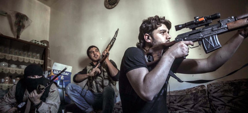 A rebel sniper aims at Syrian army positions in the Aleppo Jedida district, Syria.