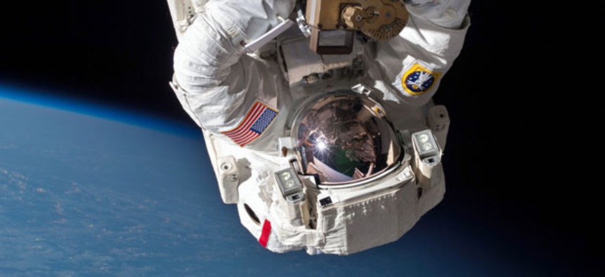 Astronaut Chris Cassidy and Tom Marshburn, not pictured, perform a space walk to inspect and replace a pump controller box on the International Space Station on May 11, 2013.