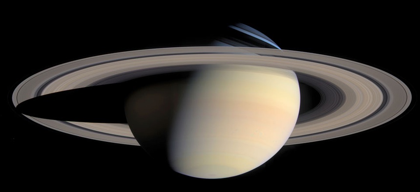 A photo taken by the Cassini Saturn Probe shows the planet Saturn and its rings.