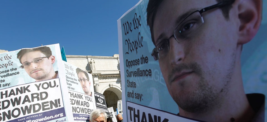 Demonstrators holds up banners with the photo of Edward Snowden during a protest outside in Washington in October.