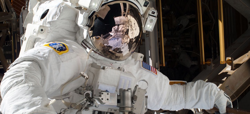 NASA astronaut Michael Hopkins, Hopkins work to repair an external cooling line on the International Space Station 260 miles above the Earth.
