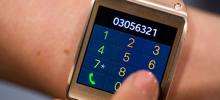 A model displays the telephone function of the new Samsung Galaxy Gear.