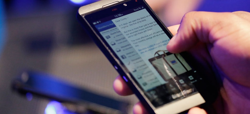 A man tests out a Blackberry smartphone in early 2013.