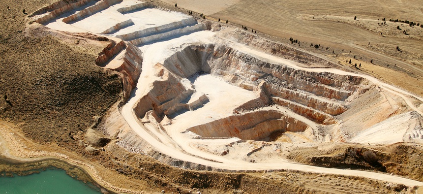 An aerial view of an open pit phosphate mine.