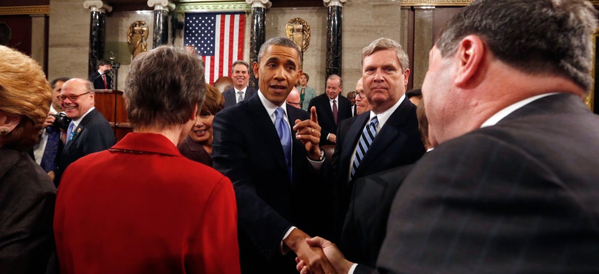 President Barack Obama shakes hands as he leaves after giving the State of Union address.