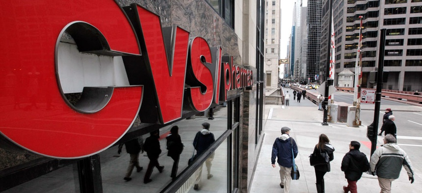 Pedestrians walk pass a CVS store in Chicago.