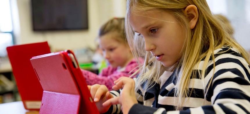 A student works on her iPad during her second grade class.