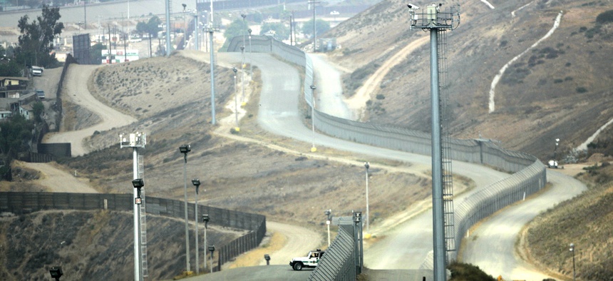 A lone Border Patrol vehicle along with tower mounted video cameras monitor activity along the border fence between Tijuana and San Diego.