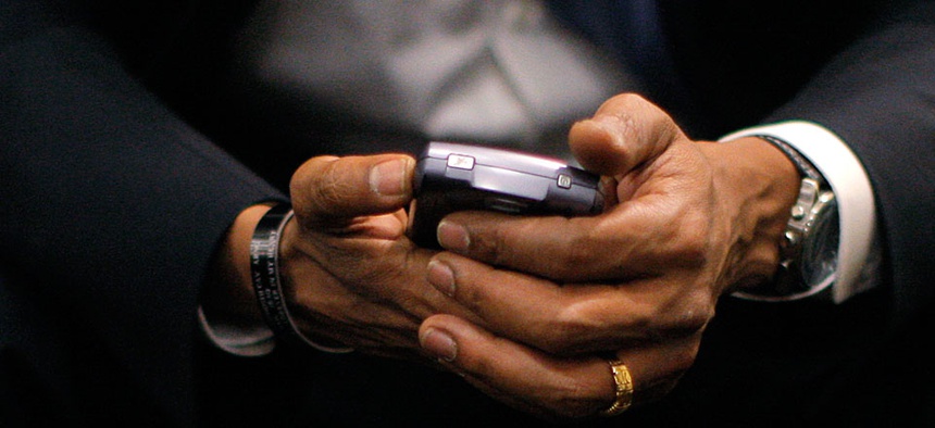 Then-Democratic presidential candidate, Sen. Barack Obama, D-Ill., checks his BlackBerry in 2008.