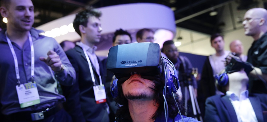 Show attendees play a video game wearing Oculus Rift headsets in January.