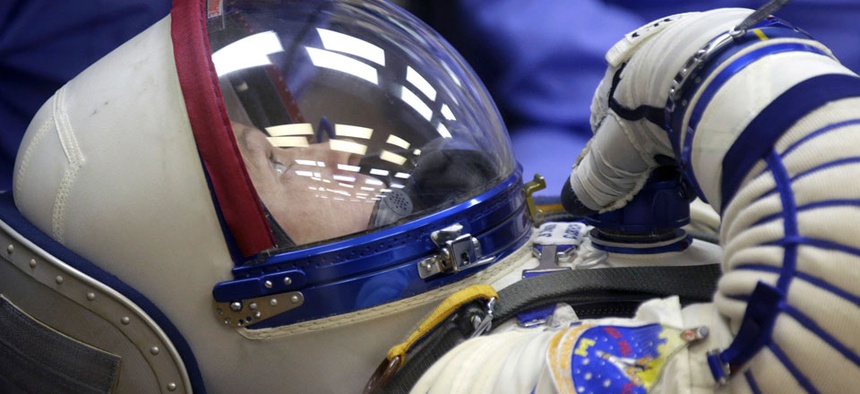 U.S. astronaut Steven Swanson, a crew member of the mission to the International Space Station (ISS) tests a space suit during pre-launch preparations.