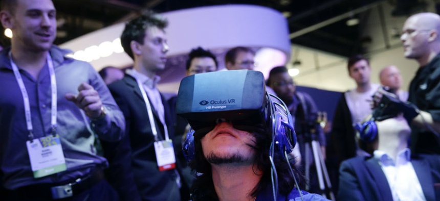 Attendees play a video game wearing Oculus Rift virtual reality headsets at the Intel booth at the International Consumer Electronics Show in Las Vegas.