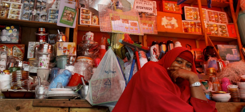 A Somali shopkeeper sells kitchen utensils sits in her shop in Mogadishu, Somalia.