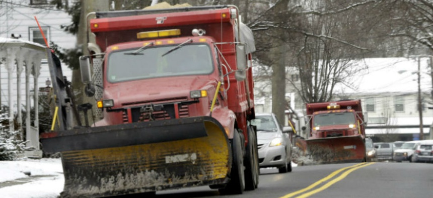 Snow plows drive down the clear streets in Allentown, N.J., Monday, March 17, 2014.