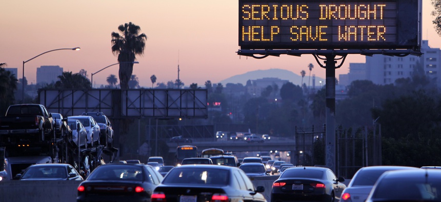 Traffic makes it's way toward downtown Los Angeles along the Hollywood Freeway past an electronic highway sign in February;