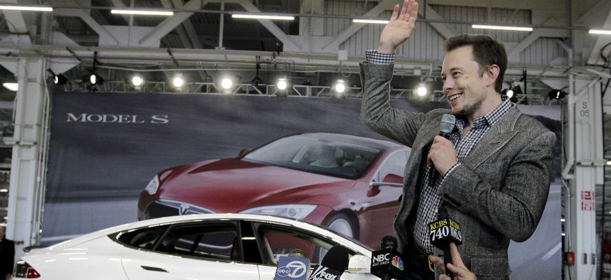 Tesla CEO Elon Musk waves during a rally at the Tesla factory in Fremont, Calif.
