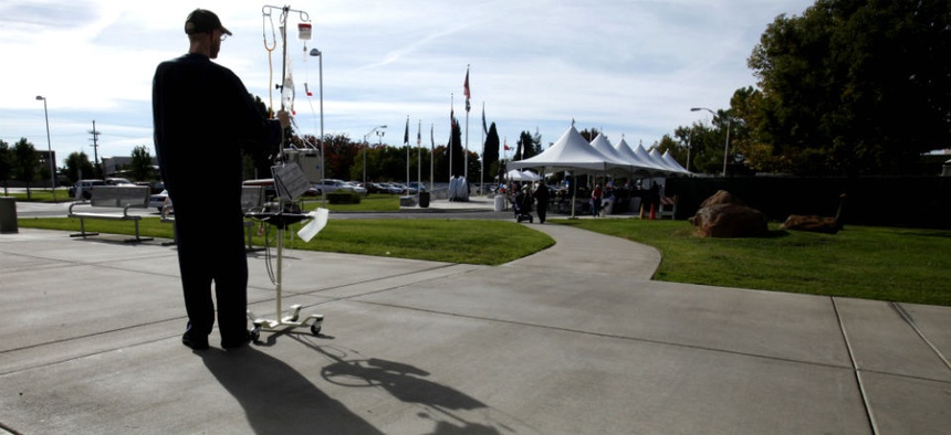 Michael Bruce, a patient at the Sacramento Veterans Affairs Medical Center, watches a Veterans Day ceremony held at the center in Rancho Cordova, Calif.