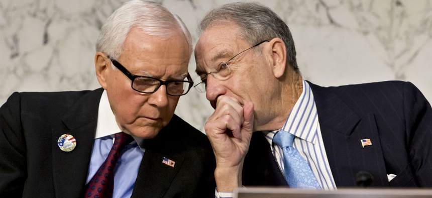 Sen. Orrin Hatch, R-Utah, ranking Republican on the Senate Finance Committee, left, talks with Sen. Chuck Grassley, R-Iowa