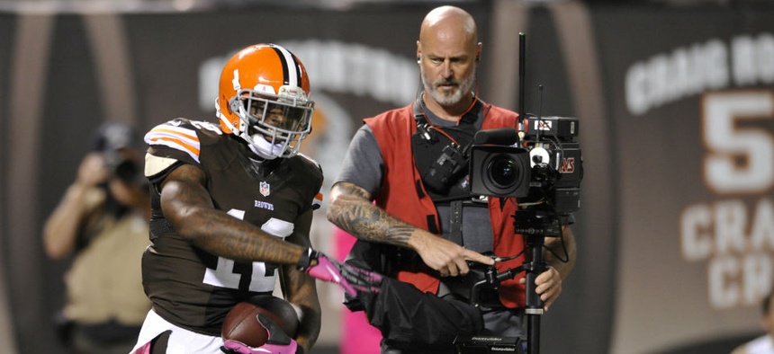 Cleveland Browns wide receiver Josh Gordon (12) celebrates beside a television cameraman during an NFL football game against the Buffalo Bills.