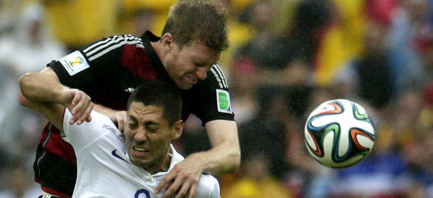 Germany's Per Mertesacker, back, and United States' Clint Dempsey go for a header during the World Cup.