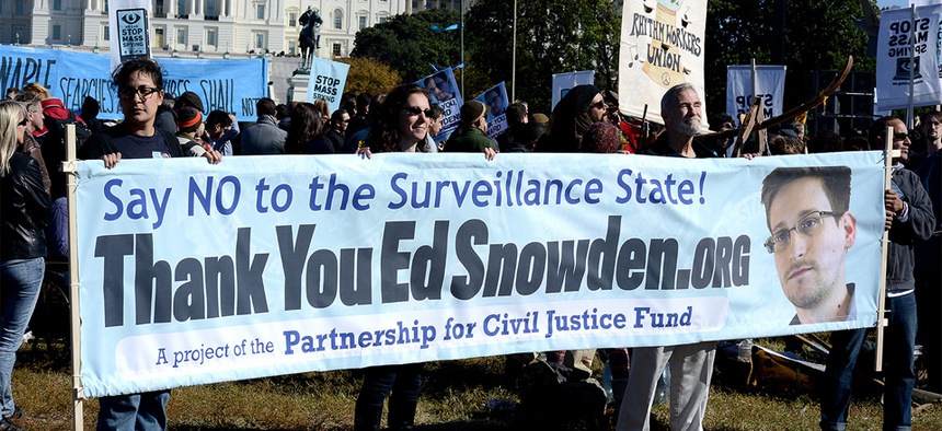 Protestors hold up a sign supporting Edward Snowden at an October rally in DC.