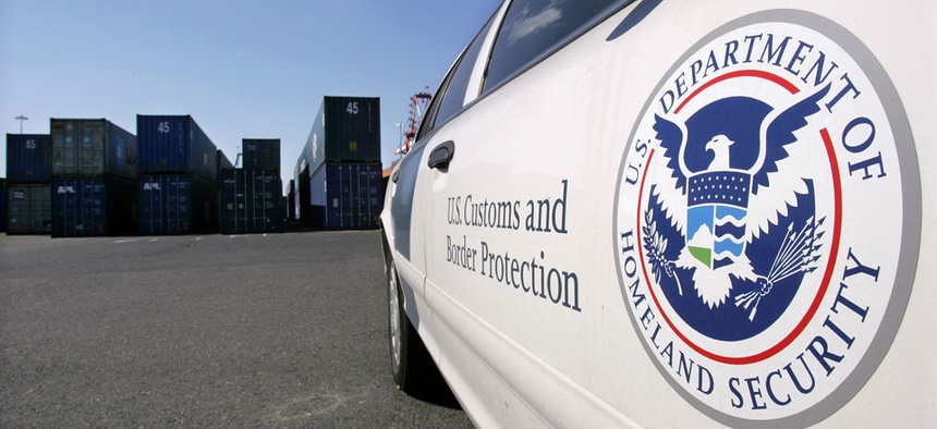 A U.S. Customs and Border Protection patrol car sits near stacked cargo containers at the port of Newark. Of the 5,000 containers that leave the seaport each day, 98 percent pass through radiation detectors.