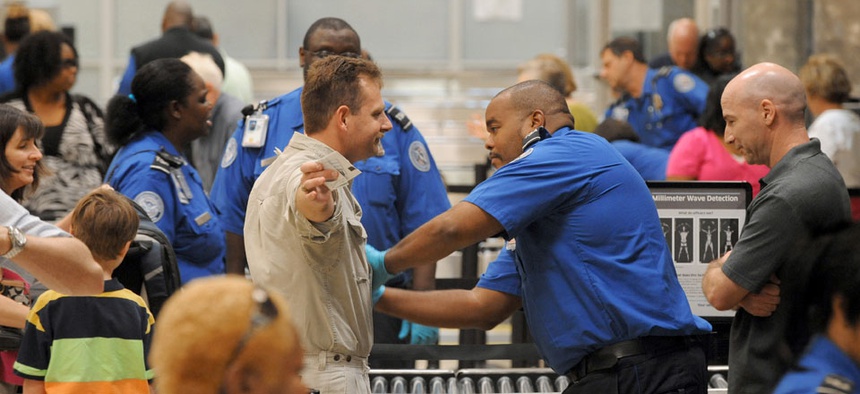 Airline passengers go through the Transportation Security Administration security checkpoint at Hartsfield-Jackson Atlanta International Airport.
