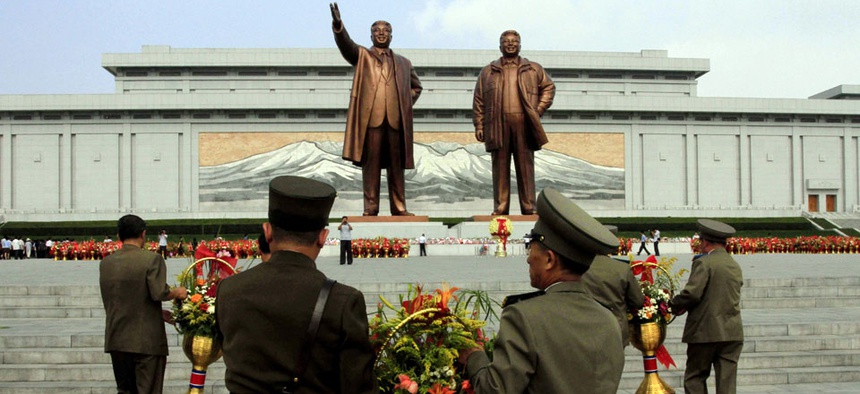 North Korean soldiers bring flowers to the statues of the late leaders Kim Il Sung, left, and Kim Jong Il in Pyongyang, North Korea.