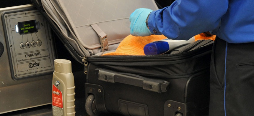 A Transportation Security Administration officer discovers unallowable liquids in a passenger's carry on luggage at the security checkpoint at Hartsfield-Jackson Atlanta International Airport.