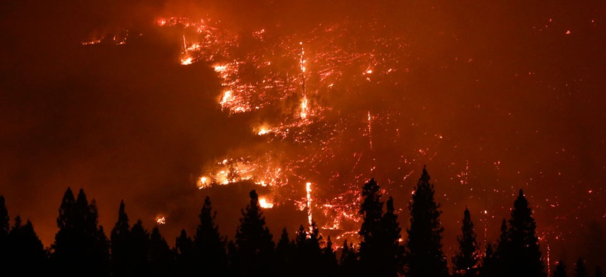 A forest smolders as the Rim Fire continues to burn near Yosemite National Park, Calif.