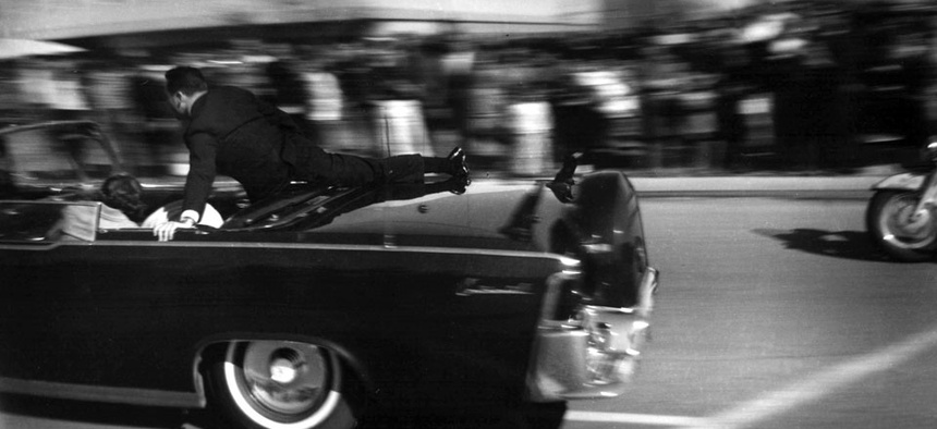 The limousine carrying mortally wounded President John F. Kennedy races toward the hospital seconds after he was shot in Dallas, on Nov. 22, 1963.