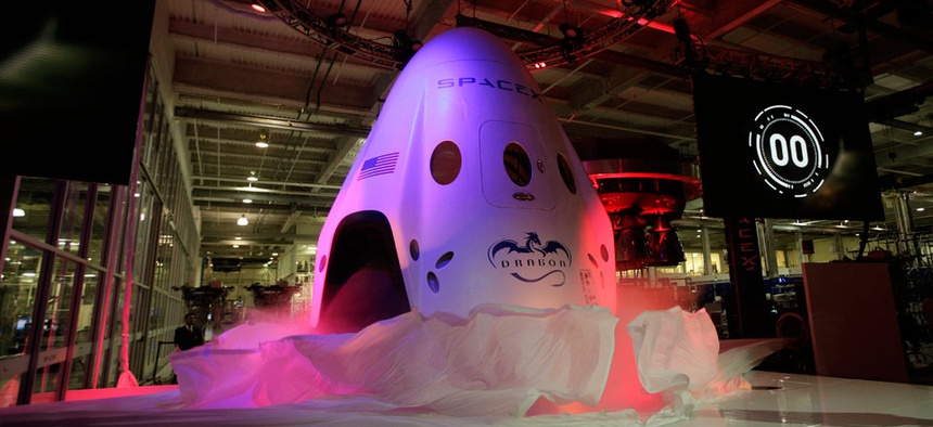 The SpaceX Dragon V2 spaceship is unveiled at its headquarters on Thursday, May 29, 2014.