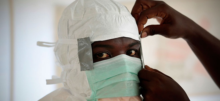 An MSF (Medecins Sans Frontieres) nurse gets prepared with Personal Protection Equipment before entering a high risk zone of MSF's Ebola isolation and treatment centre in Monrovia, Liberia.