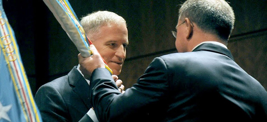 Robert Cardillo accepting the NGA colors from Undersecretary of Defense for Intelligence Michael Vickers.